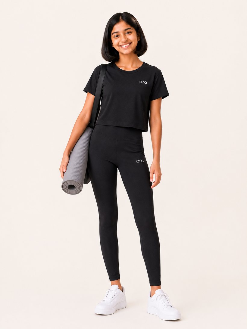 Tween in Ora boxy tee and hybrid leggings with a yoga mat
